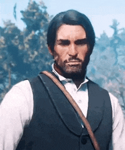 a man with a beard wearing a vest and a white shirt is standing in front of trees .