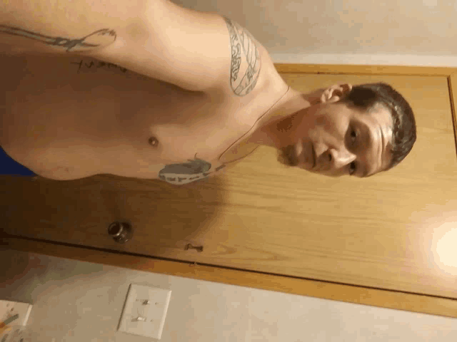 a shirtless man with a tattoo on his arm that says ' i love you '