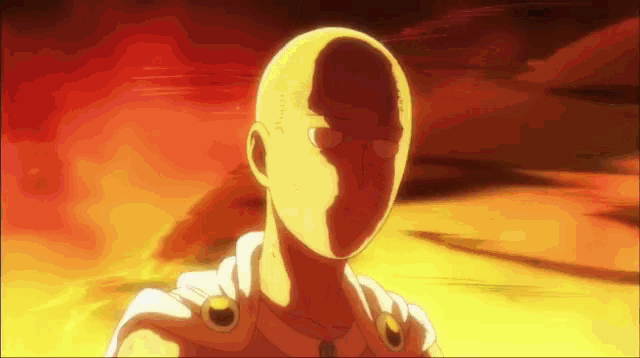 a bald man is standing in front of a fire and looking at the camera .