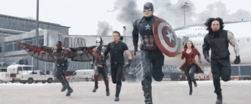 a group of superheros are running in front of a plane that says ' frankfurt ' on it