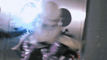 a blurry picture of a person with a purple jacket that says ' a ' on it