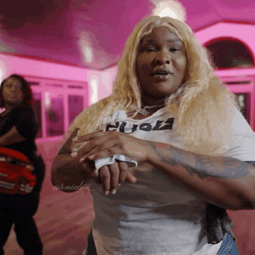 a woman wearing a t-shirt that says " fuck " is dancing