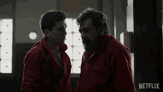 two men are standing next to each other with a netflix logo in the background