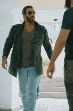 a man with a beard wearing sunglasses and a leather jacket