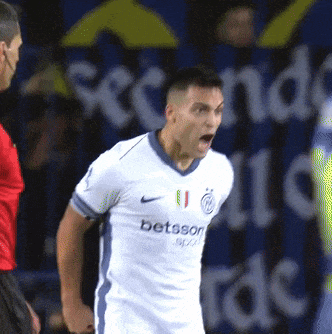 a soccer player wearing a betsson jersey is yelling at the referee
