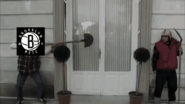 a man holding a shovel with the brooklyn nets logo