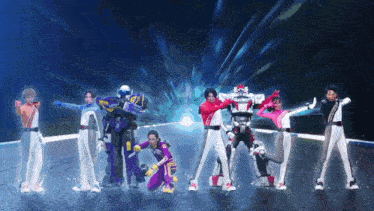 a group of people dressed as robots are standing next to each other in a line .