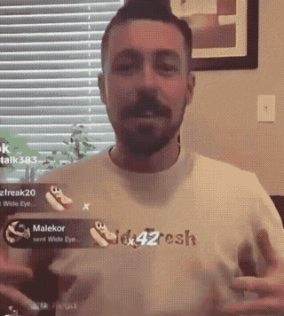 a man with a beard wearing a shirt that says malekor
