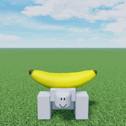 a yellow banana sitting on top of a white block with a smiley face on it