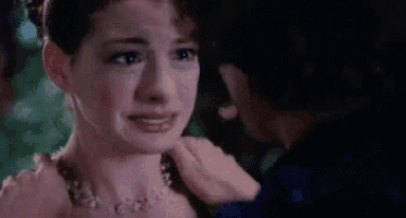 a woman is crying while a man holds her shoulder and looks at her .