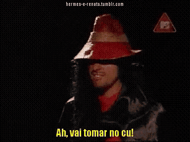 a man in a red hat says " ah vai tomar no cu " in a dark room