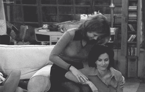 a black and white photo of two women sitting on a couch with a caption that says central park