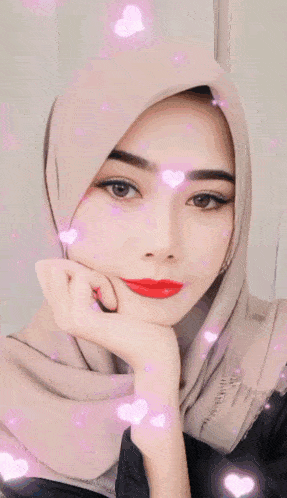 a woman wearing a hijab with the words peace love and care written above her