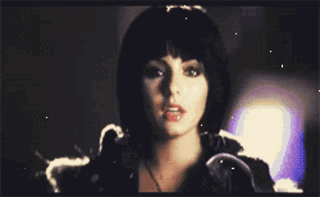 a close up of a woman with short black hair