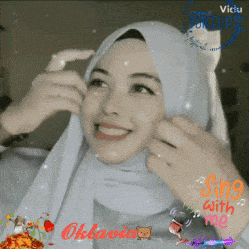 a woman wearing a white hijab is smiling with the words sing with me behind her