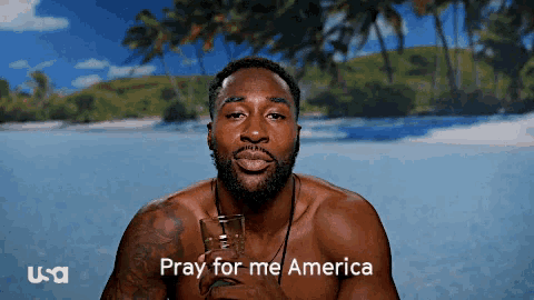 a shirtless man holding a glass with the words pray for me america behind him