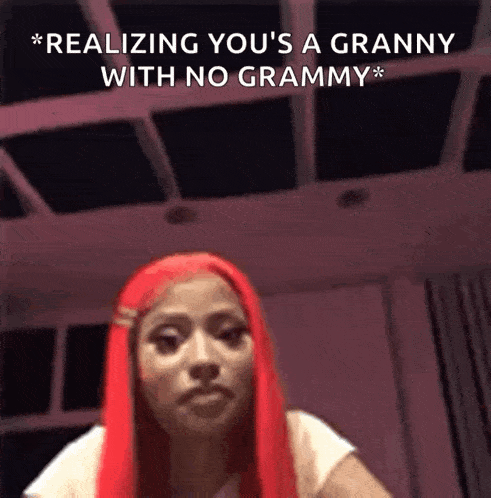 a woman with red hair is making a funny face and saying `` realizing you 's a granny with no grammy ''