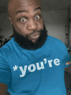 a man with a beard is wearing a blue shirt that says " you 're "