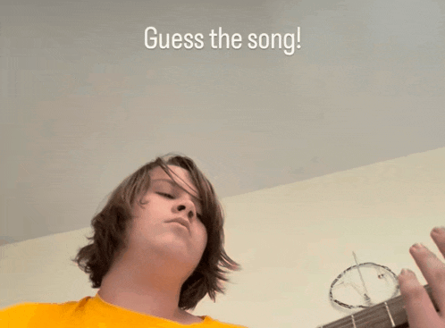 a young man playing a guitar with the words guess the song behind him