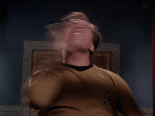 a man wearing a star trek uniform looks up at the sky