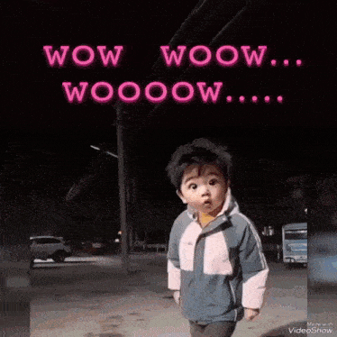 a baby is standing in front of a neon sign that says wow