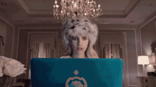 a woman wearing a fur hat is screaming with her mouth open .