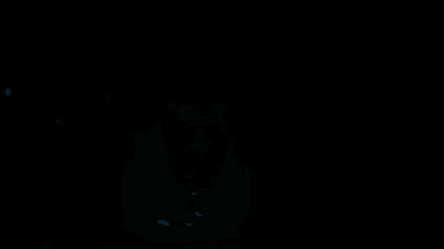 a silhouette of a person swimming in a dark pool