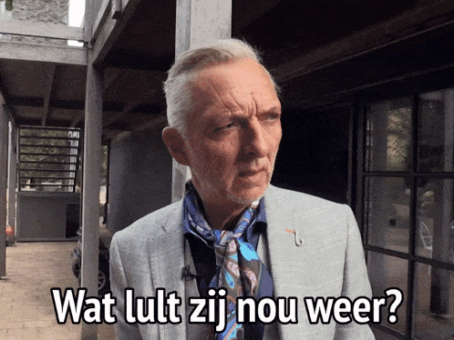 a man wearing a suit and scarf says wat lutt zij nou weer