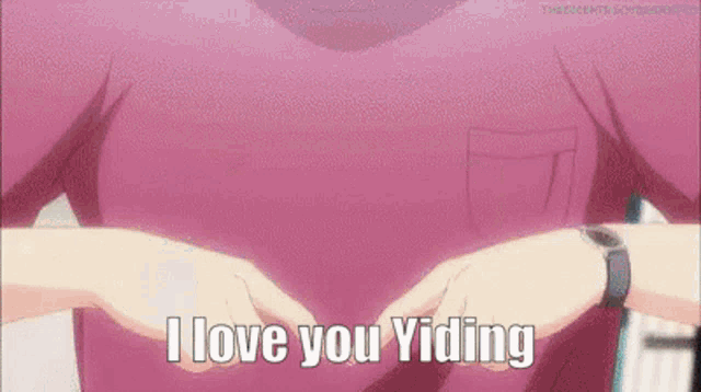 a person in a pink shirt is making a heart shape with their hands and the words `` i love you yiding '' .