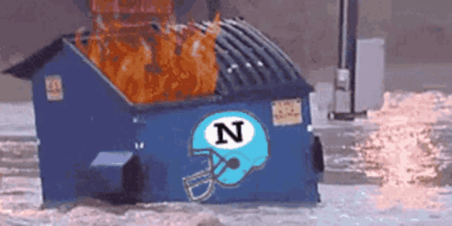 a dumpster with a football helmet on it with the letter n on it