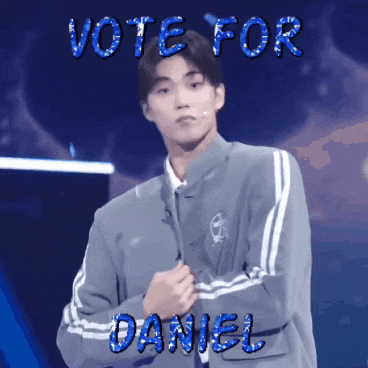 a boy in a gray jacket stands in front of a sign that says vote for daniel
