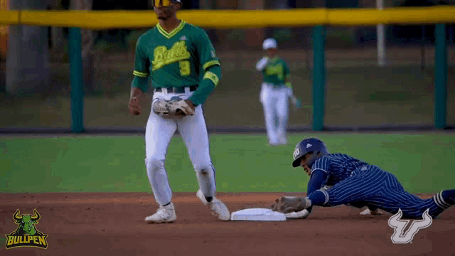 a bullpen baseball player is sliding into base