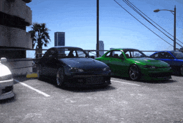 a black car is parked next to a green car in a parking lot