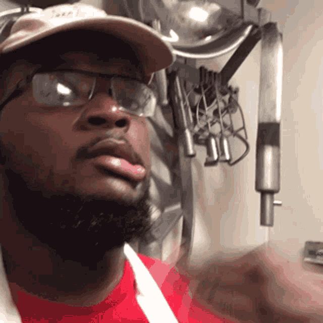 a man with a beard wearing glasses and a hat with the word jeep on it