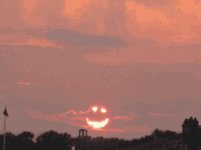 a sunset with the sun in the shape of a smiling face