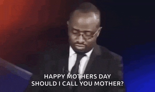 a man in a suit and tie is giving a speech and saying `` happy mothers day should i call you mother '' .