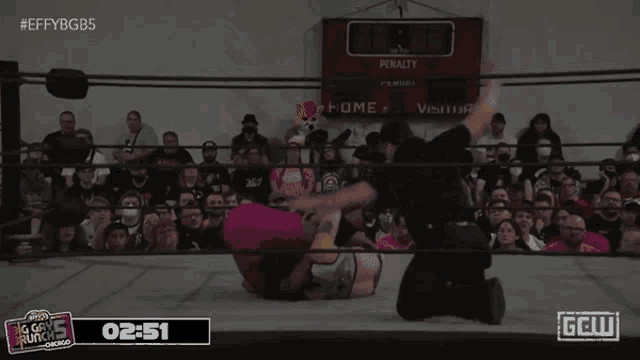 a wrestling match is being broadcasted on a screen that says gell