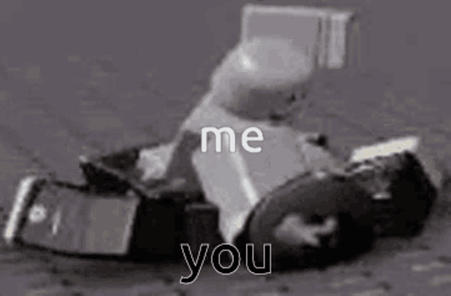 a black and white photo of a person sitting in a toy car .