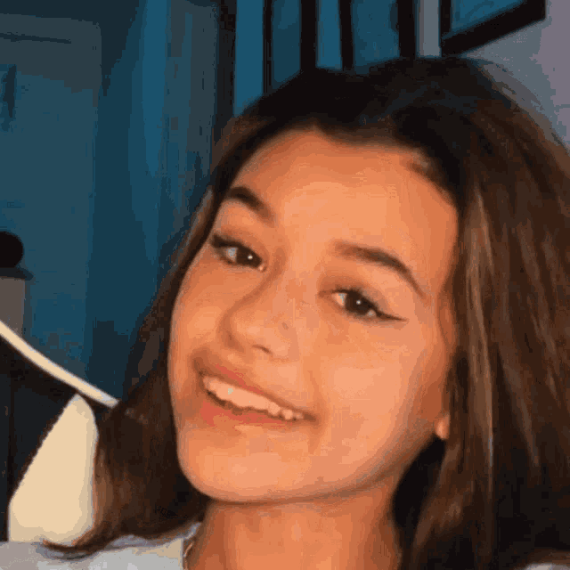 a close up of a young girl 's face smiling