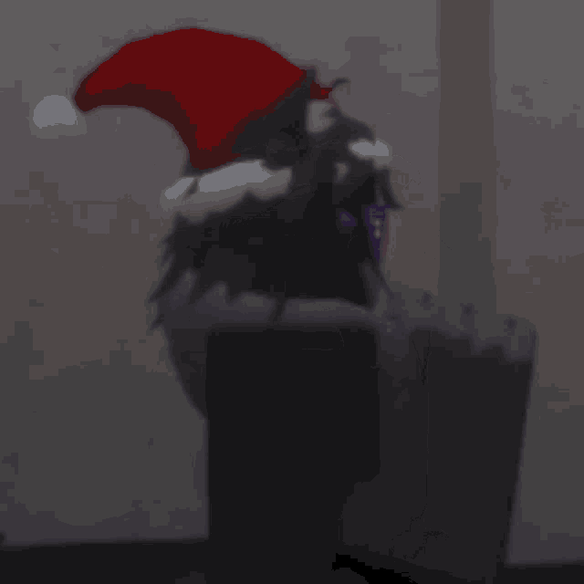 a cartoon character wearing a santa hat and glasses is sitting at a table .