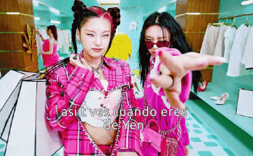two women in pink clothes are standing next to each other in a room .