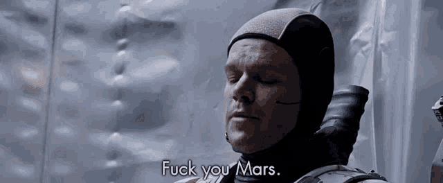 a man wearing a helmet says " fuck you mars "