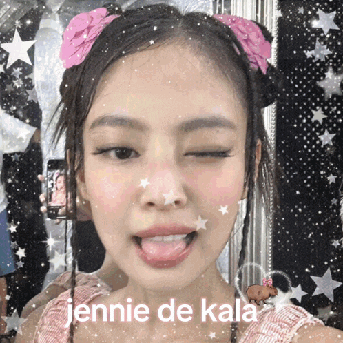 a girl with a pink flower in her hair is making a funny face and the caption says jennie de kala
