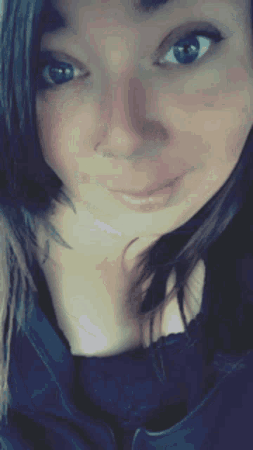 a woman with blue eyes and a nose ring