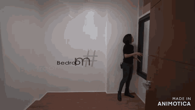 a woman is standing in a room with the word bedroom written on the wall