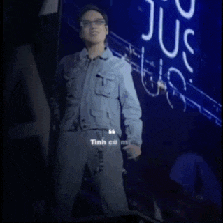 a man in a denim jacket is singing into a microphone in front of a sign that says state