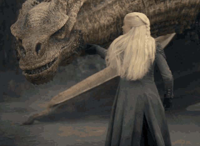 a woman in a grey dress petting a dragon