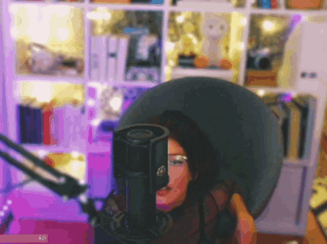a blurry picture of a woman sitting in front of a microphone with the letters ap on the bottom right