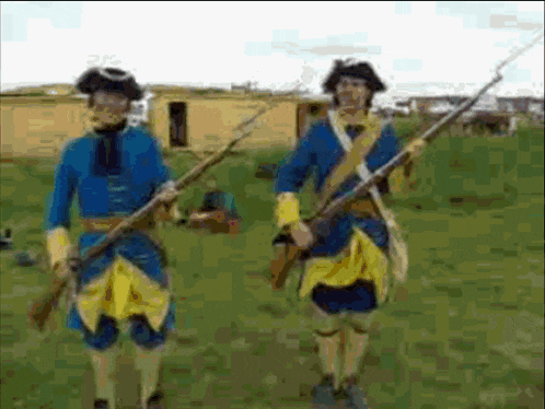 two men in blue and yellow uniforms holding guns