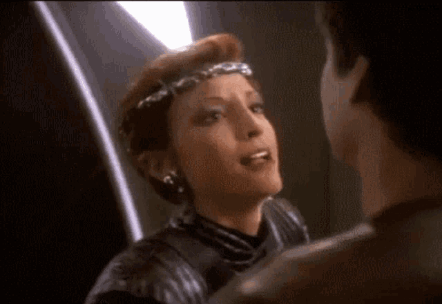 a man and a woman are standing next to each other in a room .